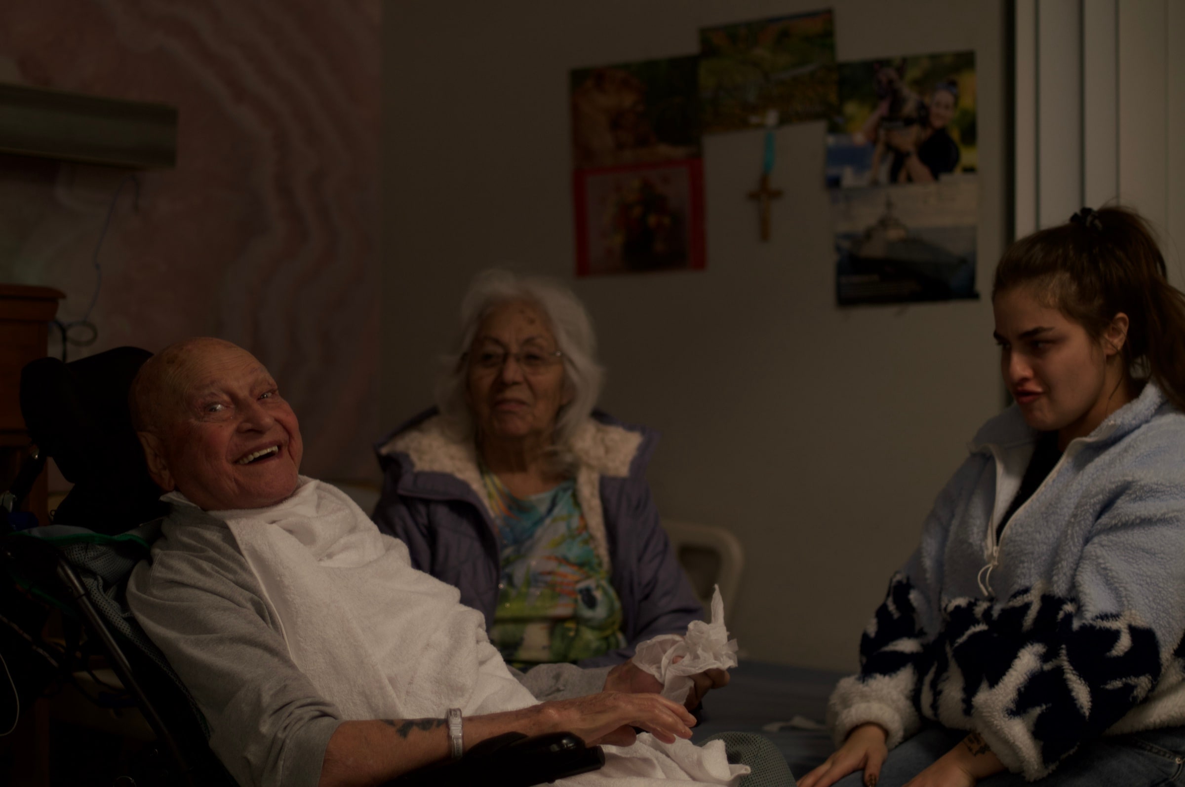 Three people sitting together in a living room.